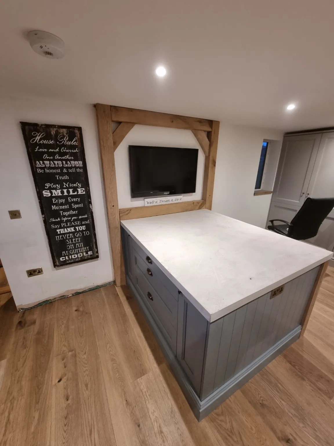 Bespoke fitted kitchen island and oak TV surround